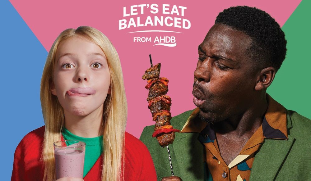Young girl with a pink smoothie and a man with a meat kebab.